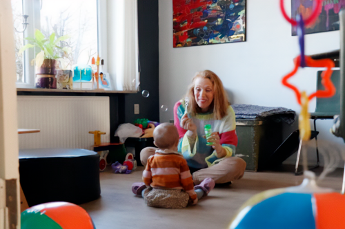 En voksen og et barn leger med sæbebobler